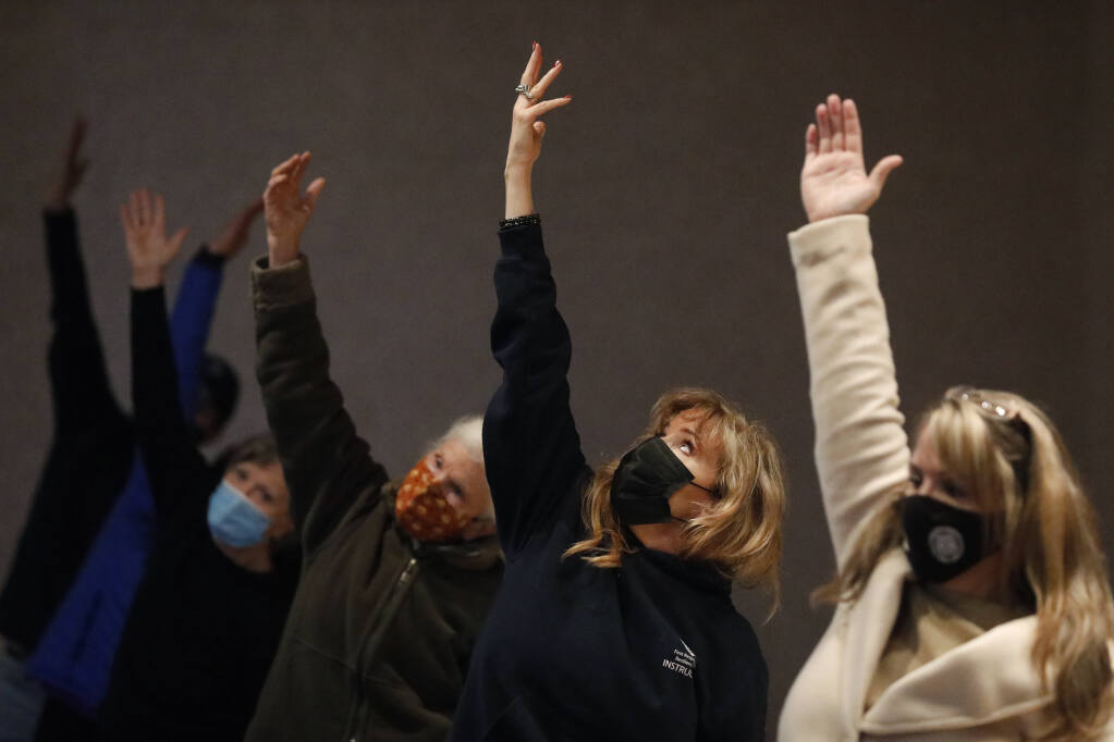 Susan Farren, second from right, practices yoga during a retreat organized by First Responder Resilience LLC at Charles Krug Winery in St. Helena , Calif., on Wednesday, December 15, 2021.(Beth Schlanker/The Press Democrat)