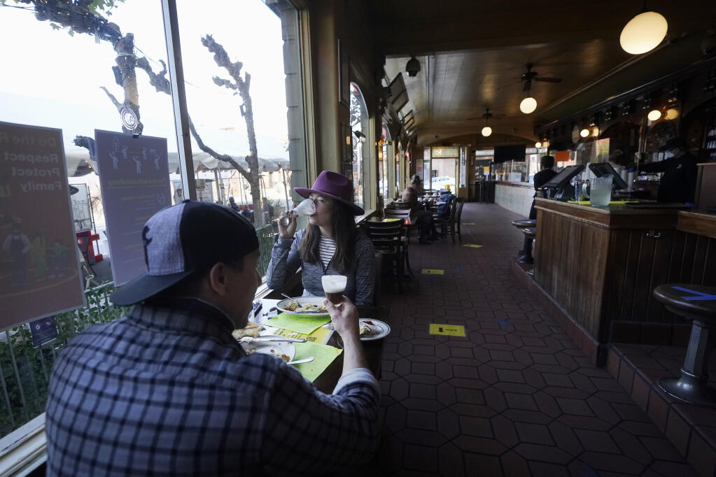 Mitchell Bryant, left, and Darla Scott eat inside at the Buena Vista Cafe during the coronavirus outbreak in San Francisco, Thursday, Nov. 12, 2020. California on Thursday became the second state — behind Texas — to eclipse a million known cases, while the U.S. has surpassed 10 million infections, according to data compiled by Johns Hopkins University.(AP Photo/Jeff Chiu)