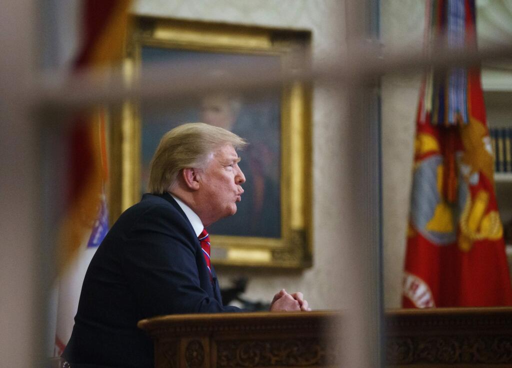 FILE- In this Tuesday, Jan. 8, 2019, file photo seen from a window outside the Oval Office, President Donald Trump gives a prime-time address about border security at the White House in Washington. With the standoff over paying for his long-promised border wall dragging on, the president's Oval Office address and visit to the Texas border over the past week failed to break the logjam and left aides and allies fearful that the president has misjudged Democratic resolve and is running out of negotiating options. (AP Photo/Carolyn Kaster, File)