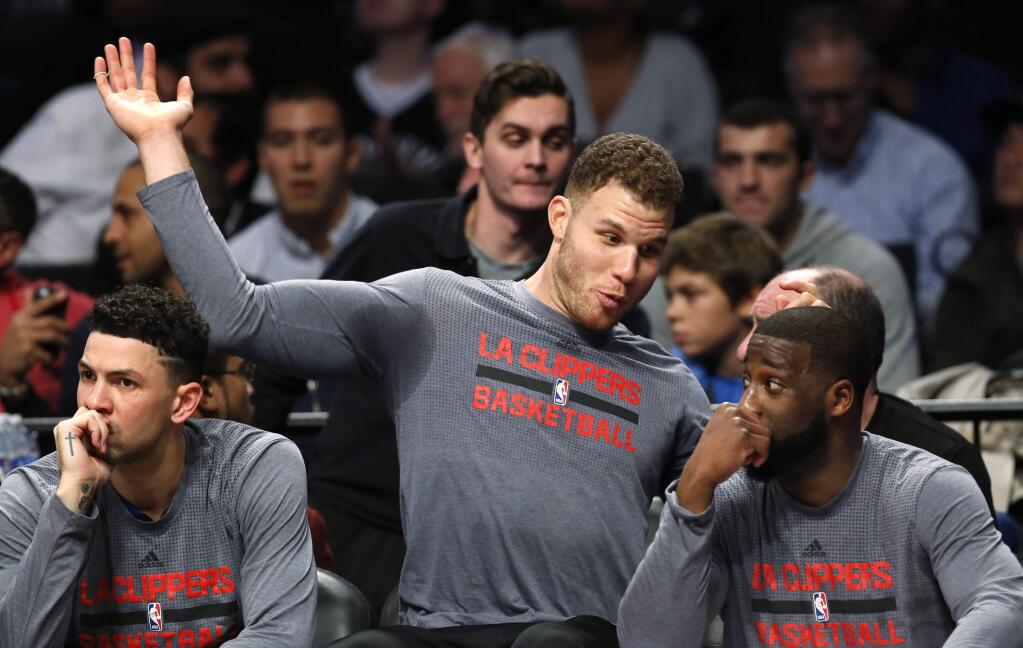 File-This Nov. 29, 2016, file photo shows Los Angeles Clippers' Blake Griffin, center, gesturing as he talks to teammate Ray Felton, right, during the first half of the team's NBA basketball game against the Brooklyn Nets. The extra week, which allows the regular season to start Oct. 17, the league's earliest start since 1980, was an obvious help. But schedule makers went further, taking a deeper-than-usual look at arena availability around the league and trying to minimize the nights where a weary team will face a well-rested opponent. In other words, NBA fans, meet FTE. The metric, an acronym for Fresh, Tired and Even, is a major part of the NBA schedule process. (AP Photo/Kathy Willens, File)