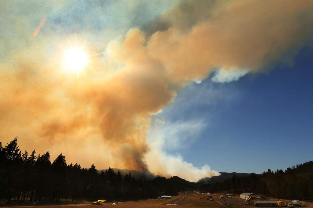 A large plume of smoke rises over the town of Oakridge as the Deception Complex Fire continues to burn Thursday, Aug. 28, 2014. (AP Photo/The Register-Guard, Chris Pietsch)
