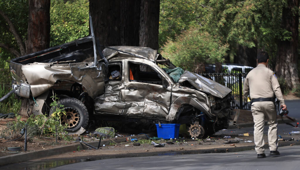 A Sonoma County Transit bus was struck by a gold pickup., along River Road at Korbel Winery, Thursday, Oct. 7, 2021.  The bus pushed the truck around 50 feet before it came to a stop against trees fronting the winery.  The driver of the pickup was killed.  (Kent Porter / The Press Democrat)