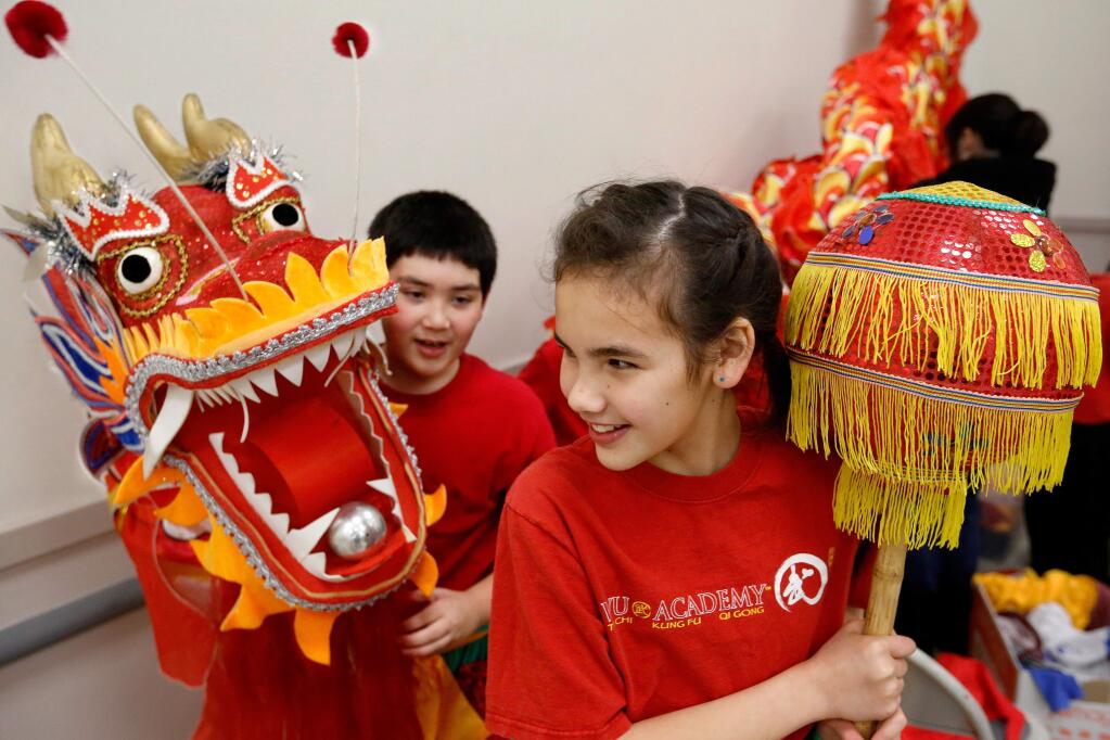 Dragon dancers Keelyn Walker, 10, right, and Nicky Ringstad, 8, get ready to perform during the Chinese New Year celebration presented by the Redwood Empire Chinese Association at Veterans Memorial Hall in Santa Rosa, California on Saturday, February 18, 2017. (Alvin Jornada / The Press Democrat)
