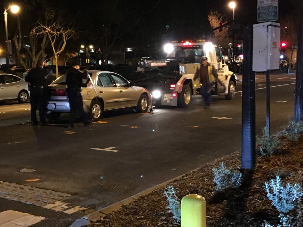 A car driven by a woman suspected of DUI after hitting two pedestrians in a Petaluma crosswalk is towed off the street, Saturday, Dec. 19. (Photo by Luke Entrup)
