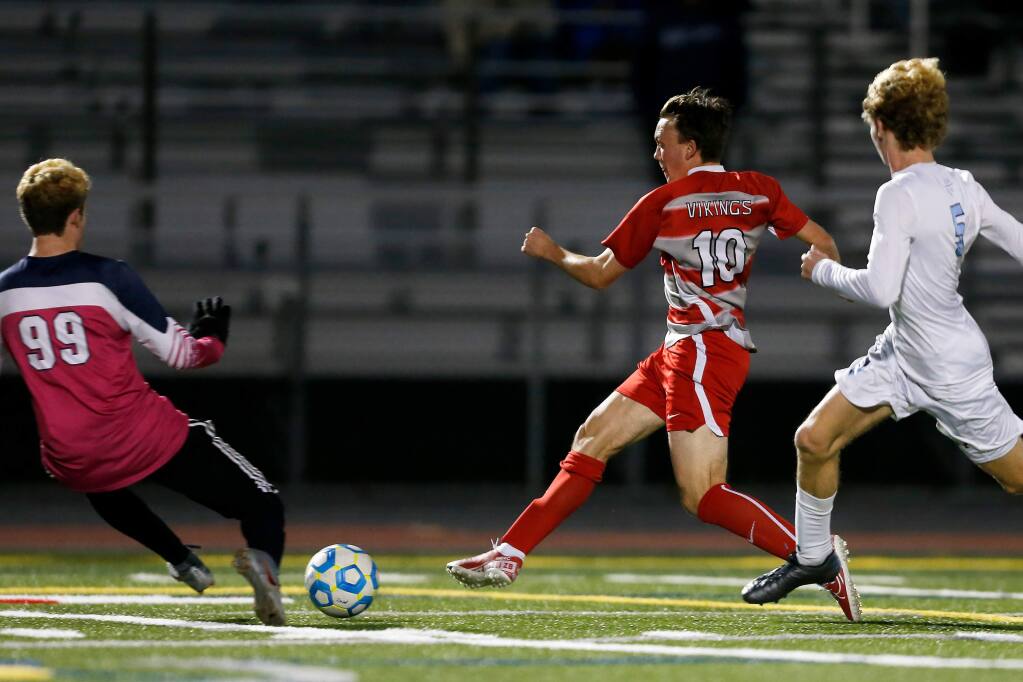 Montgomery's Zack Batchelder, second from right, kicks the ball past Bellarmine goalkeeper Ben Galdes to score during the first half of the NorCal playoffs semifinal game in Santa Rosa on Thursday, March 5, 2020. (Alvin Jornada / The Press Democrat)