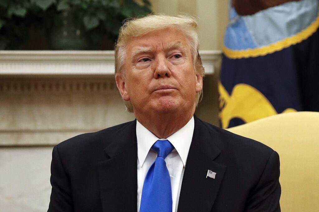 In this July 25, 2017, photo, President Donald Trump sits in the Oval Office of the White House in Washington. Trump is likely to sign a tough new sanctions bill that includes proposed measures targeting Russia _ a remarkable concession that the president has yet to sell his party on his hopes for forging a warmer relationship with Moscow. (AP Photo/Pablo Martinez Monsivais)