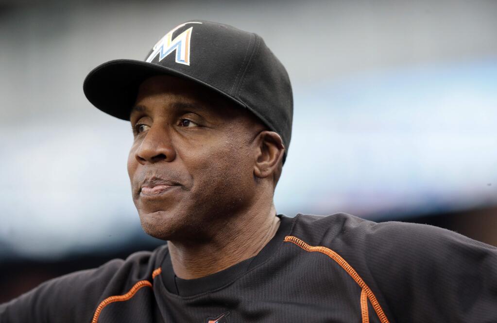 In this June 28, 2016, file photo, Miami Marlins hitting coach Barry Bonds looks from the dugout during the first inning against the Detroit Tigers in Detroit. Bonds has joined the San Francisco Giants front office as a special adviser, the team announced Tuesday, March 21, 2017. Bonds, who hit 762 career home runs, was fired last fall as the hitting coach for the Marlins after one season. (AP Photo/Carlos Osorio, File)