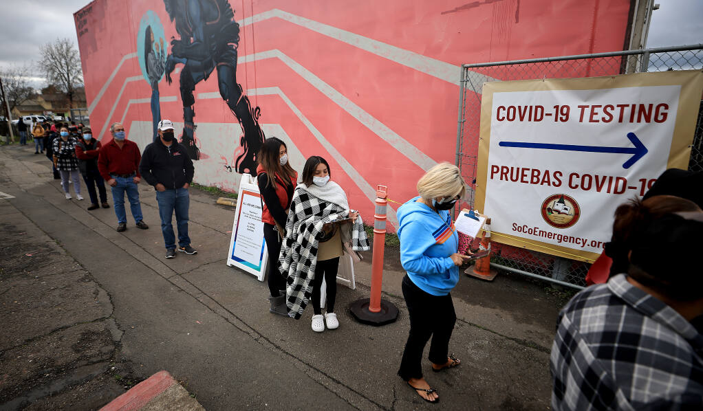 At the Roseland Community Center, Wednesday, Jan. 5, 2022, a long of people wait to be tested for COVID-19 in Santa Rosa. (Kent Porter / The Press Democrat)