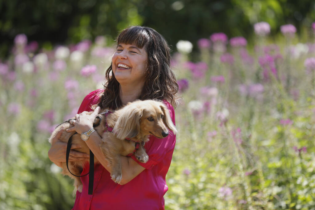 Sarah Doyle and her dog Sophie Francine at Kendall-Jackson Winery and Gardens in Santa Rosa, Calif. on Thursday, August 4, 2022. (Beth Schlanker/The Press Democrat)
