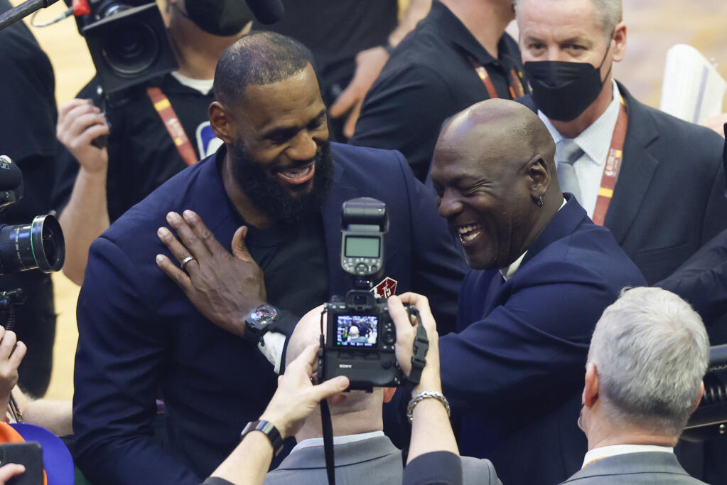 Los Angeles Lakers' LeBron James, left, and former NBA great Michale Jordan greet each other during the introduction of 75 of the leagues greatest player during halftime at the NBA All-Star basketball game, Sunday, Feb. 20, 2022, in Cleveland. (AP Photo/Ron Schwane)