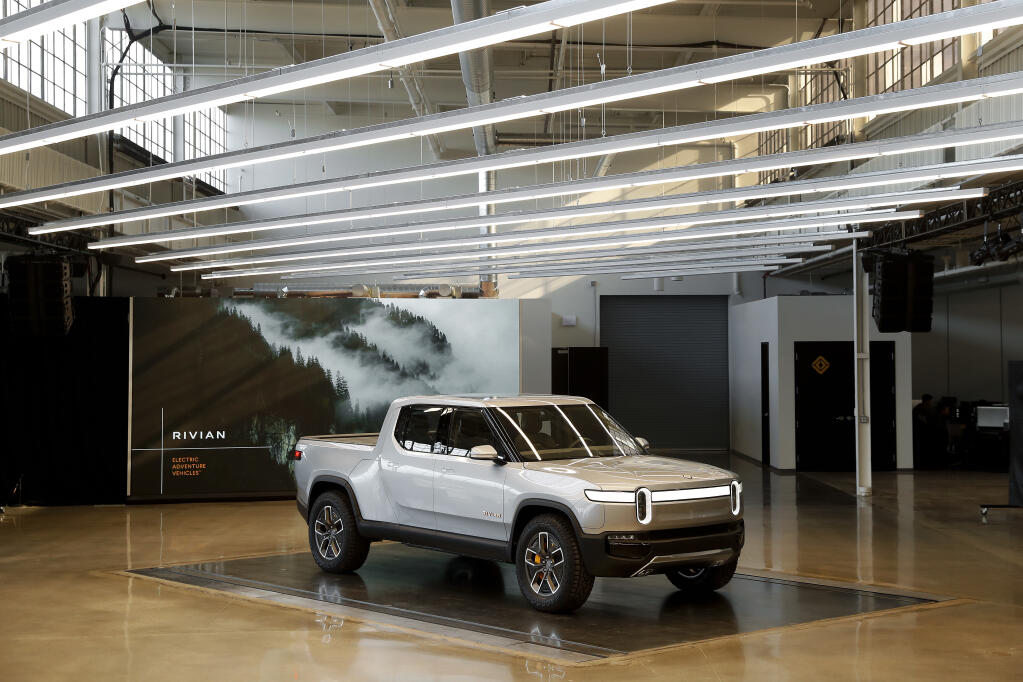 FILE - This Nov. 14, 2018 photo shows a Rivian R1T at Rivian headquarters in Plymouth, Mich. Rivian Automotive, a company that went public a day ago and hopes to produce 1,000 electric vehicles by the end of the year, will surpass General Motors to become the nation’s second most valuable automaker if an overnight surge in the price of its shares hold. The California company’s market valuation exceeded Ford’s in its first day of trading Wednesday and with shares up 6% before the opening bell Thursday, Nov. 11, 2021 that valuation hit $90 billion to surpass GM, a company that sold more than 2.5 million vehicles last year. (AP Photo/Paul Sancya, file)