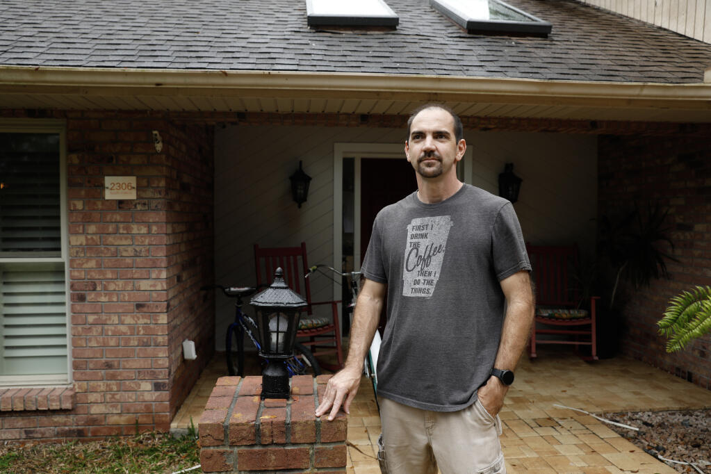 Robert Shiver, who reduced his home’s insurance coverage when the bill more than doubled, stands in front of his house in Valrico, Fla. on Jan. 16, 2024. Insurers’ losses from natural disasters topped $100 billion for the fourth straight year in 2023, and they are passing those costs on to property owners. (Octavio Jones/The New York Times)