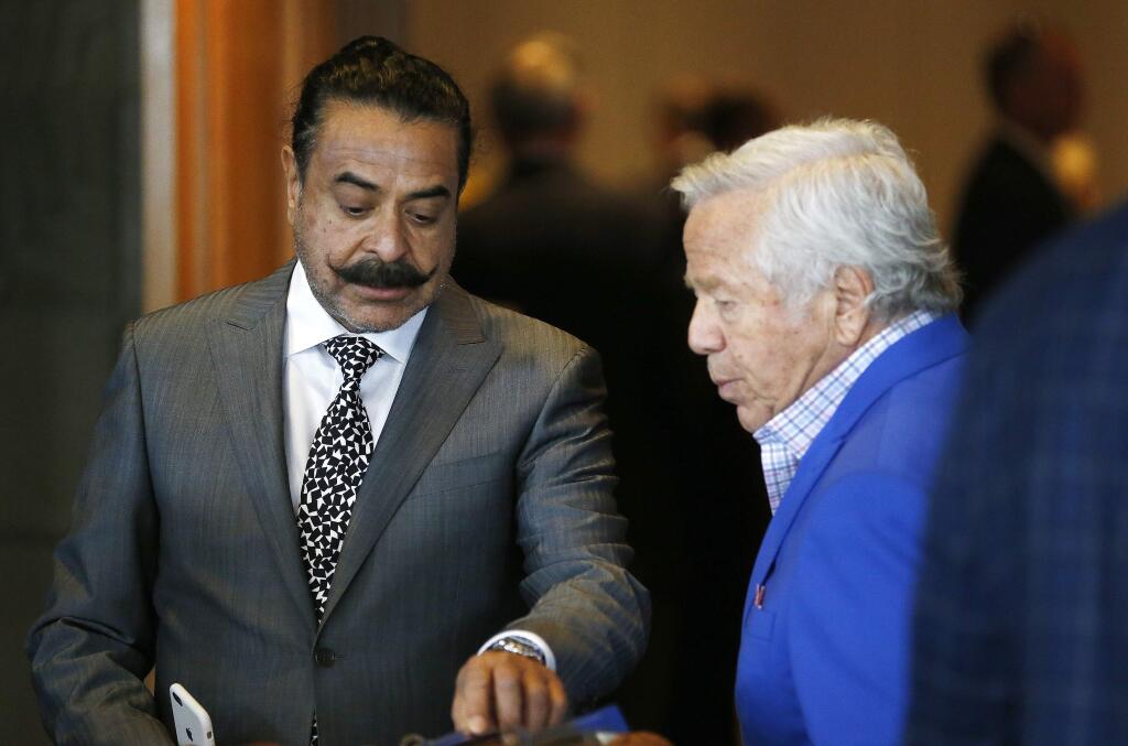 Jacksonville Jaguars owner Shahid Khan, left, talks with New England Patriots owner Robert Kraft, right, at the NFL football meetings Monday, March 27, 2017, in Phoenix. (AP Photo/Ross D. Franklin)