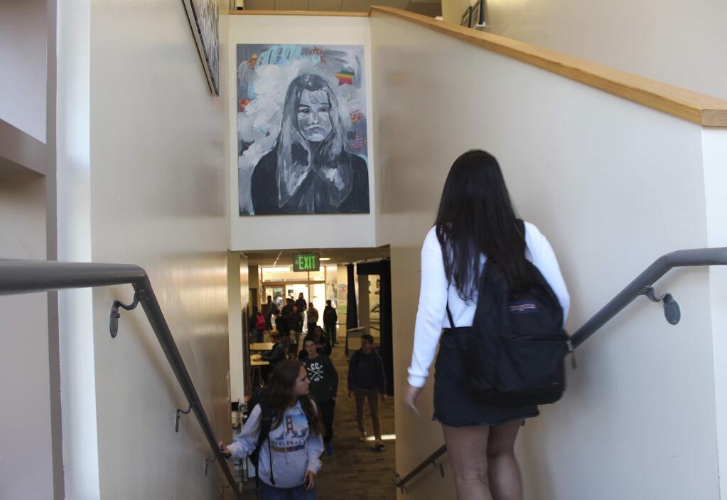 In this Tuesday, Jan. 30, 2018 photo provided by Sophia Muys, students pass under one of James Franco's paintings displayed above a stairwell in the Media Arts Center at Palo Alto High School in Palo Alto, Calif. Actor and director Franco is a 1996 graduate of the school. Franco's former high school has taken down a mural he painted and plans to remove other art donated by the celebrity alumnus who is facing allegations of sexual misconduct in Hollywood. A statement from the school district Thursday, Feb. 1, 2018, said removing the artwork was 'in the best interests of our students.' (Sophia Muys/Paly Voice via AP)