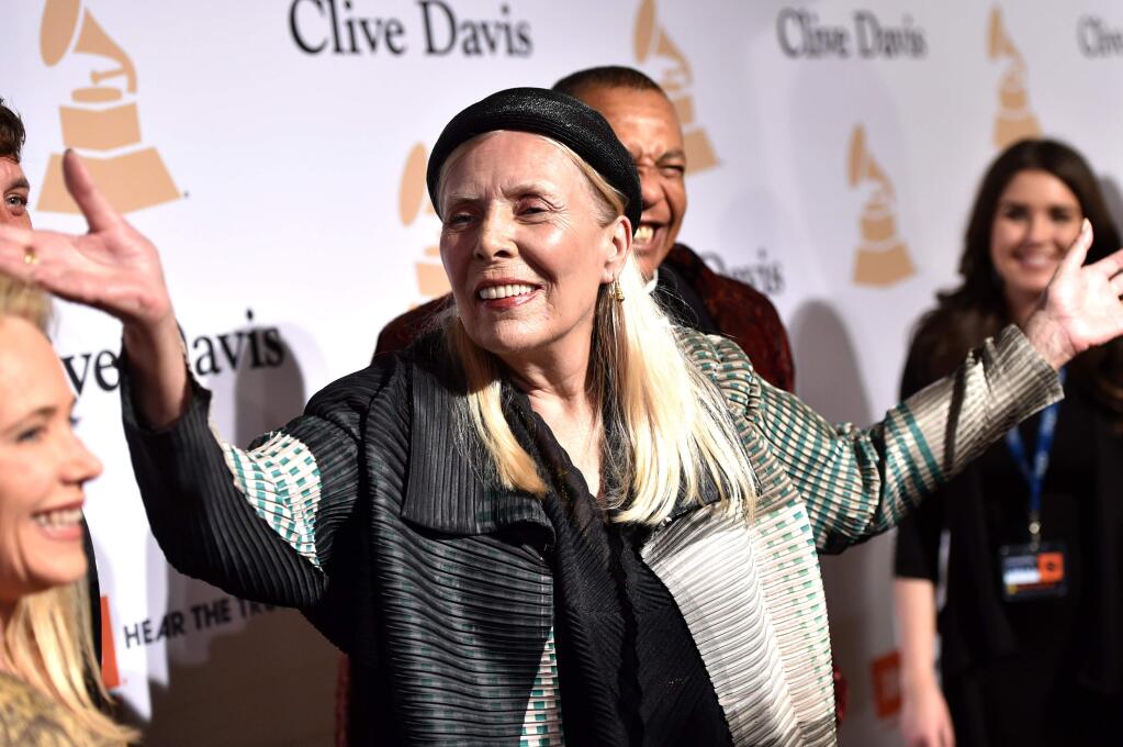In this Feb.7, 2015 file photo, Joni Mitchell arrives at the 2015 Clive Davis Pre-Grammy Gala at the Beverly Hilton Hotel in Beverly Hills, Calif. Mitchell was hospitalized in Los Angeles on Tuesday, March 31, 2015 according to the Twitter account and website of the folk singer and Rock and Roll Hall of Famer, but details on her condition have not been released. (Photo by John Shearer/Invision/AP, File)