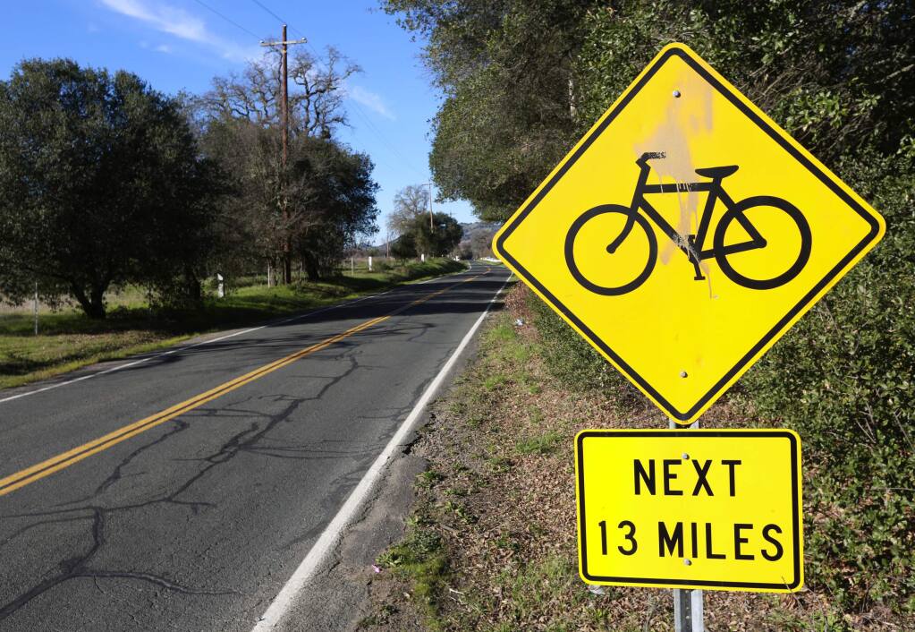 Signs warn drivers of cyclists on Old River Road heading north from Hopland. (JOHN BURGESS/ PD)