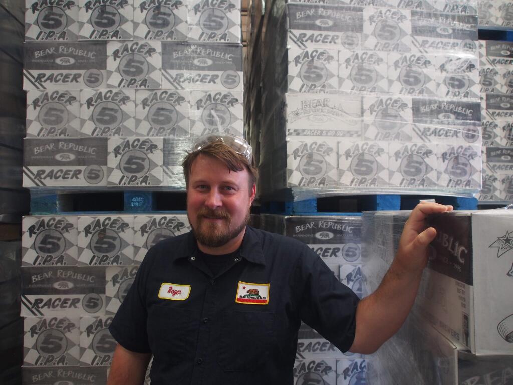 Bear Republic Brewing Brewmaster Roger Herpst with cases of Racer 5 IPA, a craft brew staple in many bars, at the company's Cloverdale brewery / Chase DiFeliciantonio, North Bay Business Journal