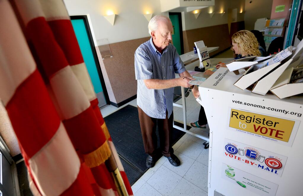 Ed Striepeke drops his mail-in ballot into a ballot box at the Registrar of Voters in Santa Rosa. (Kent Porter / PD FILE)