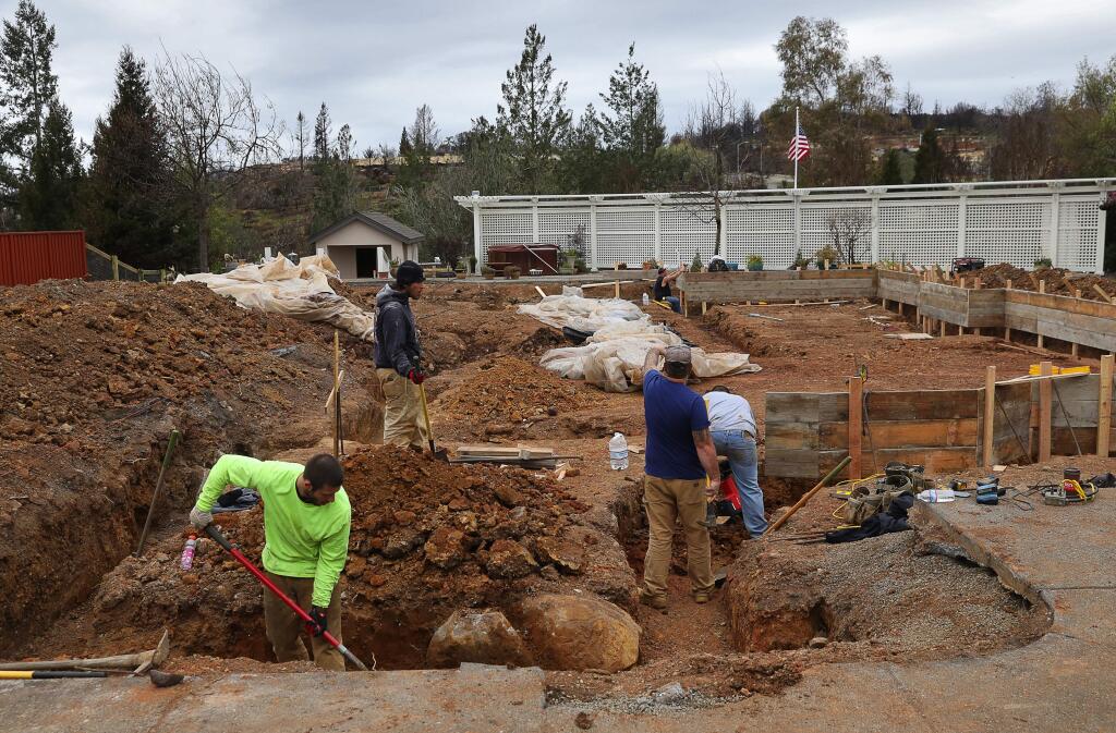 Construction workers begin work on rebuilding Jim Roatch's home along Hadley Hill, in the Fountaingrove area of Santa Rosa on Wednesday, February 28, 2018. Roatch had to have 85 tons of dirt removed from his property before building could commence, because arsenic was found in soil samples.(Christopher Chung/ The Press Democrat)