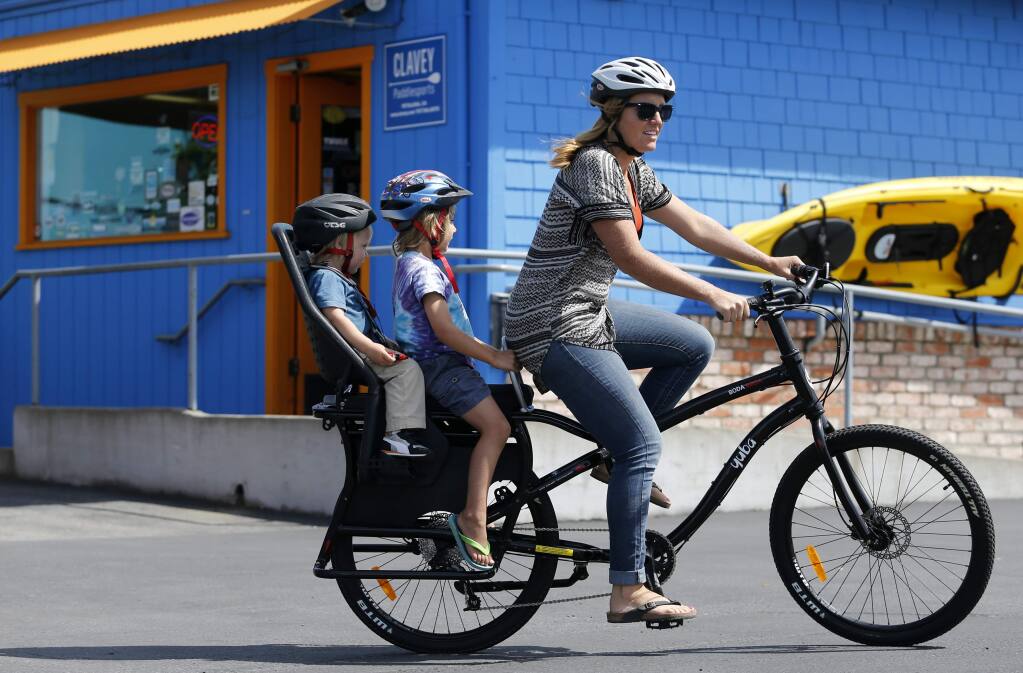 Julie Mercer-Ingram, wife of Matthew Ingram who is the Director of Marketing and Partnerships for Yuba Bicycles, rides a Boda Boda All-Terrain bicycle with her two sons Elias Ingram, 5, and Arlo, 2, in the parking lot at Yuba Bicycles on Thursday, May 19, 2016 south of Petaluma, California . (BETH SCHLANKER/ The Press Democrat)