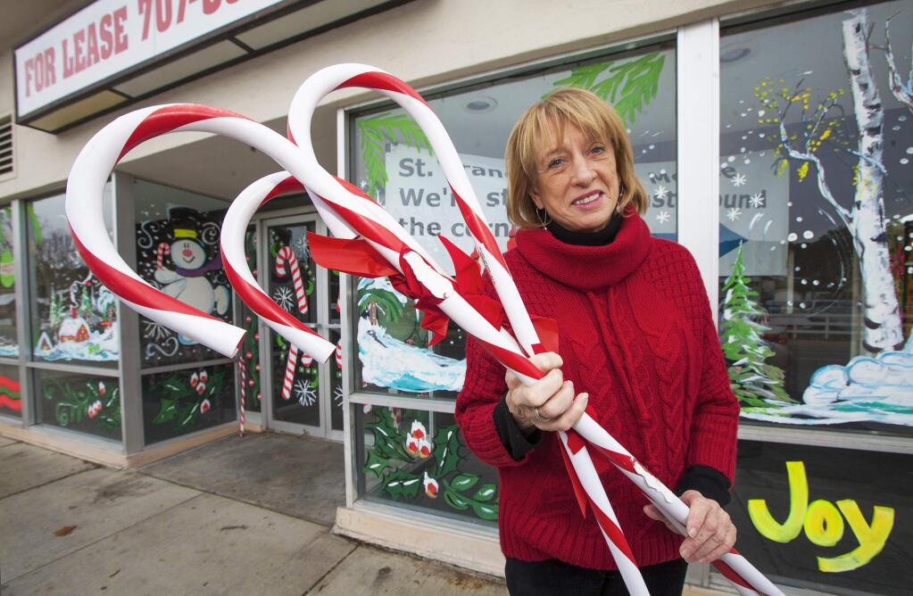 Constance Grizzle in front of the storefront next to the Boyes Boulevard Post Office that they will use until after Christmas. (Photo by Robbi Pengelly/Index-Tribune)