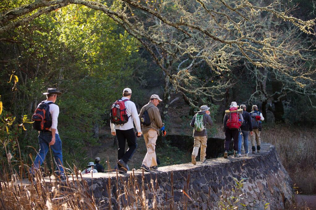 A group of hikers walk across the dam surrounding London's Lake during a Bill & Dave Hike, sponsored by Sonoma County Regional Parks, Team Sugarloaf, and Valley of the Moon Natural History Association. (Charlie Gesell/PD File)