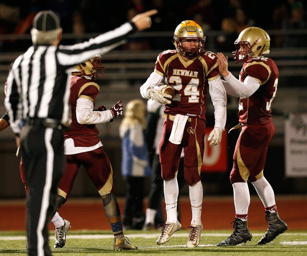 Cardinal Newman's Mike Daly (32), right, Mark Boschetti (24), and Damian Wallace (8) celebrate Boschetti's interception of a St. Bernard's pass during the first half of the NCS Division 4 championship football game in Rohnert Park on Saturday, Dec. 3, 2016. (Alvin Jornada / The Press Democrat)