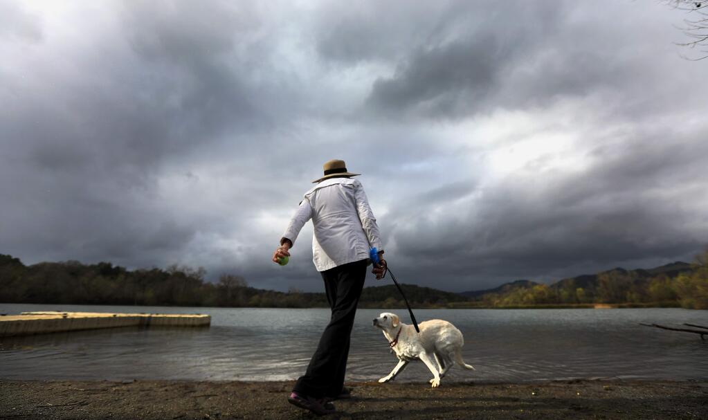 Myrtle Edmiston throws a tennis ball for her 11 year-old lab Brandy at Spring Lake in Santa Rosa, Thursday March 1, 2018. (Kent Porter / Press Democrat) 2018