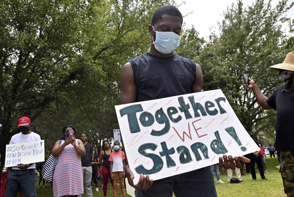 Protesters gather outside the Glynn County Courthouse during a rally to protest the shooting of Ahmaud Arbery, Saturday, May 16, 2020, in Brunswick, Ga. (Hyosub Shin/Atlanta Journal-Constitution via AP)