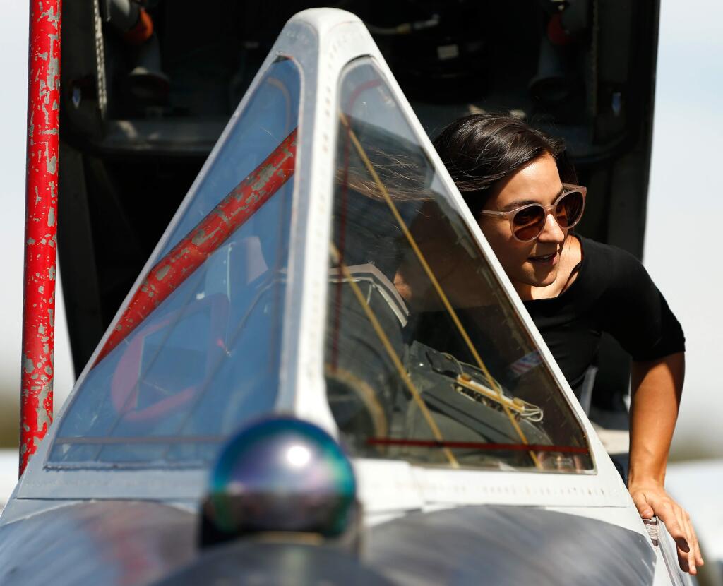 Emily Bonnin of Santa Rosa climbs into the cockpit of an F-106 Delta Dart display aircraft during the Wings Over Wine Country airshow at Charles M. Schulz-Sonoma County Airport in Santa Rosa, California, on Saturday, September 22, 2018. (Alvin Jornada / The Press Democrat)