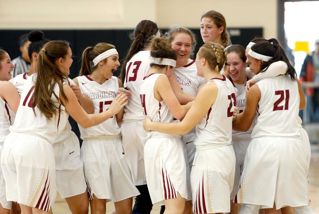 The Cardinals celebrate their championship win over Menlo School, with a score of 51-32, during the CIF NorCal Division 4 girls basketball championship game between Cardinal Newman and Menlo School, in American Canyon, California on Saturday, March 19, 2016. (Alvin Jornada / The Press Democrat)