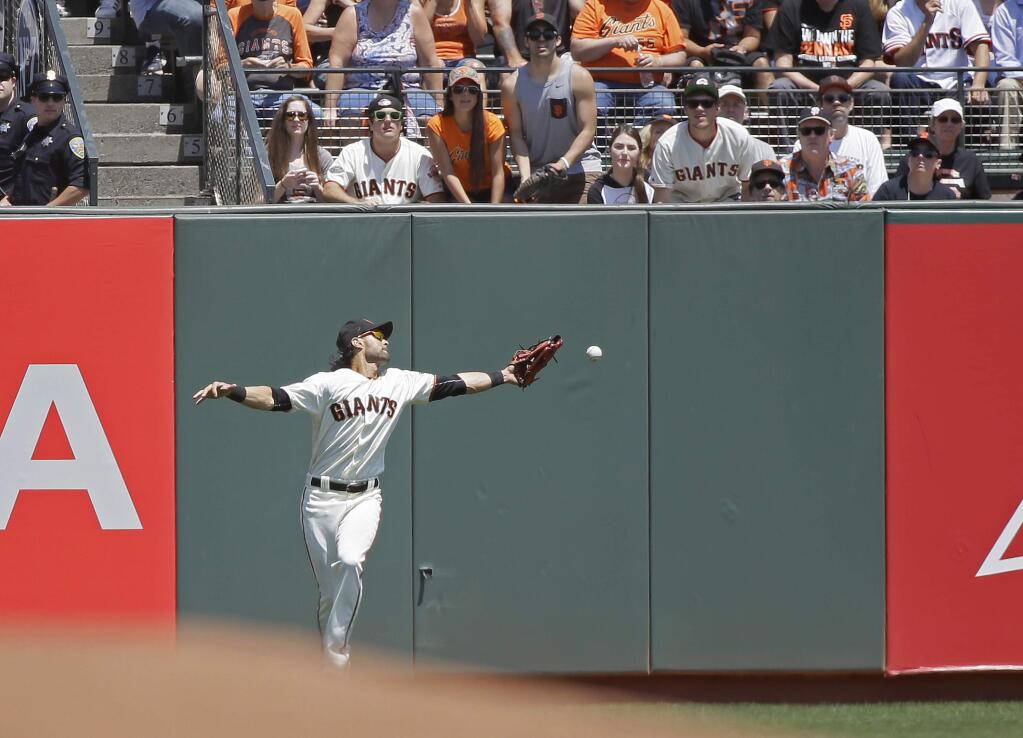 San Francisco Giants left fielder Angel Pagan misses a fly ball hit by the Cincinnati Reds' Eugenio Suarez in the fifth inning Wednesday, July 27, 2016, in San Francisco. Pagan was charged with an error on the play. (AP Photo/Eric Risberg)