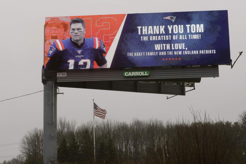 A billboard featuring an image of former New England Patriots quarterback Tom Brady stands along Route 1, in Walpole, Mass., about a mile from Gillette Stadium, which is in Foxborough, Mass., Thursday, March 19, 2020. The Kraft family and the New England Patriots signed off on a message on the sign meant to honor the quarterback. Robert Kraft is the owner of the football team. Brady said on social media on Tuesday, March 17, 2020 that he would not be returning to the Patriots and has become a free agent. (AP Photo/Steven Senne)