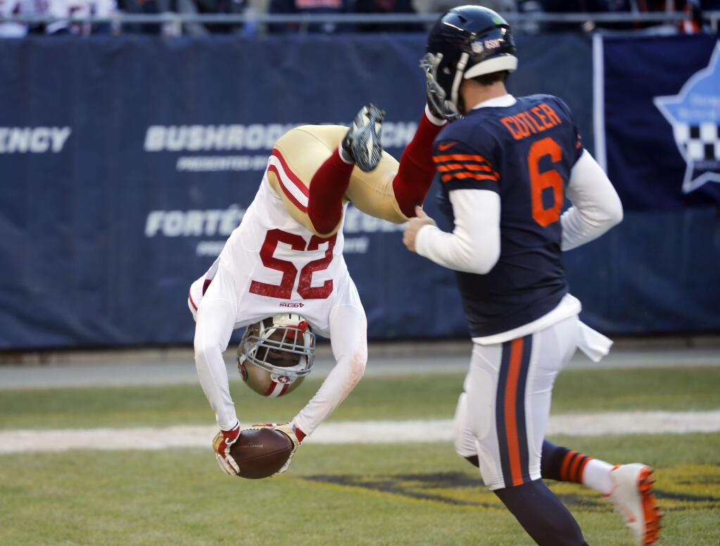 San Francisco 49ers safety Jimmie Ward dives to the end zone for a touchdown after intercepting a pass as Chicago Bears quarterback Jay Cutler watches during the first half Sunday, Dec. 6, 2015, in Chicago. (AP Photo/Charles Rex Arbogast)