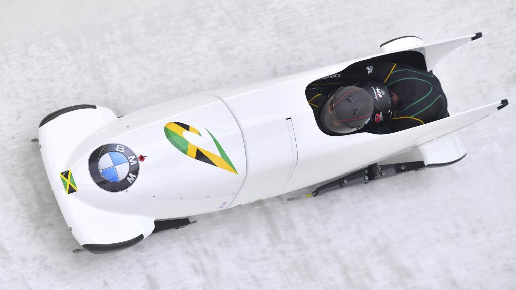 Jazmine Fenlator-Victorian and Carrie Russell of Jamaica speed down the track during their first run of the women's World Cup bobsled race in Innsbruck, Saturday, Dec. 16, 2017. (AP Photo/Kerstin Joensson)