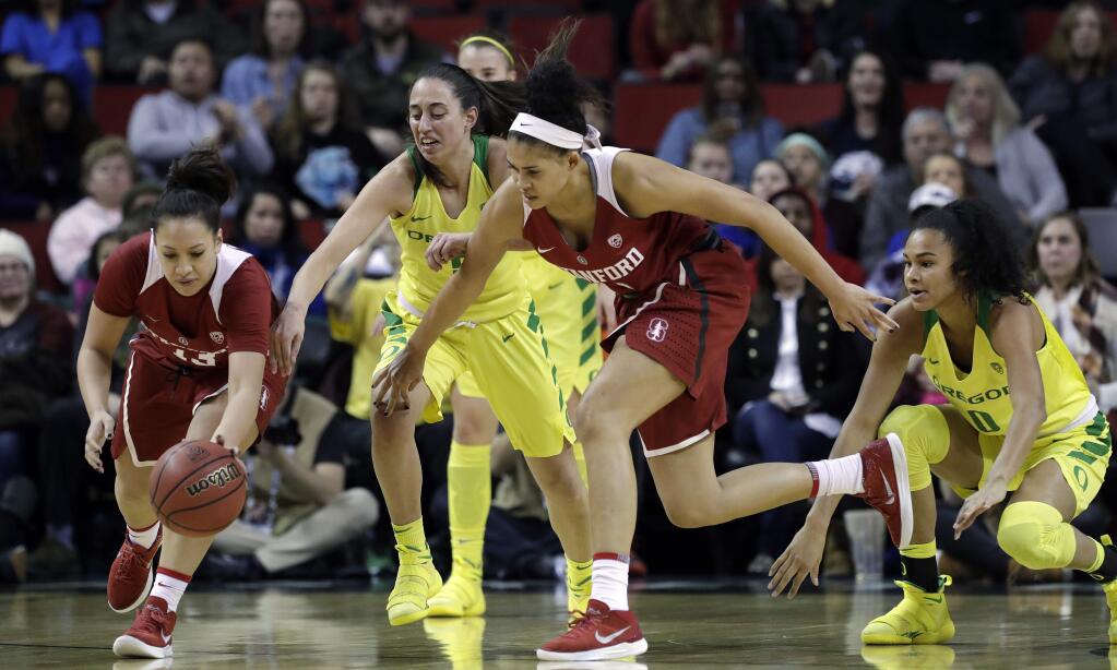 Stanford's Marta Sniezek, left, and Kaylee Johnson chase a loose ball with Oregon's Maite Cazorla, second left, and Satou Sabally during the first half of an NCAA college basketball game in the finals of the Pac-12 Conference women's tournament, Sunday, March 4, 2018, in Seattle. (AP Photo/Elaine Thompson)