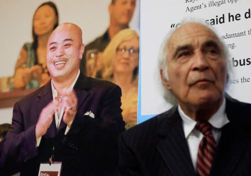 In this 2014 file photo, Tony Serra, right, an attorney for Raymond 'Shrimp Boy' Chow, pictured at left, listens to speakers at a San Francisco news conference. (AP Photo/Jeff Chiu)