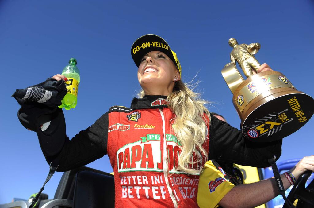 In this photo provided by the NHRA, Leah Pritchett celebrates after a recent race. Pritchett is third in the Top Fuel points standing this year.