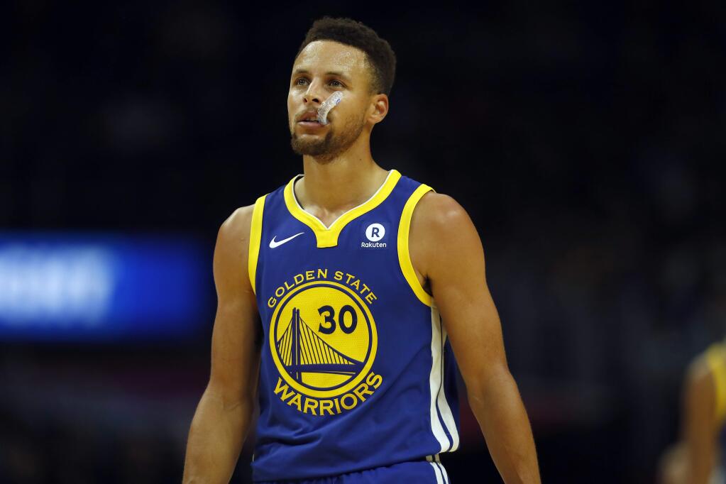 Golden State Warriors guard Stephen Curry chews on his mouthguard during the second half against the Los Angeles Clippers, Monday, Oct. 30, 2017, in Los Angeles. (AP Photo/Ryan Kang)