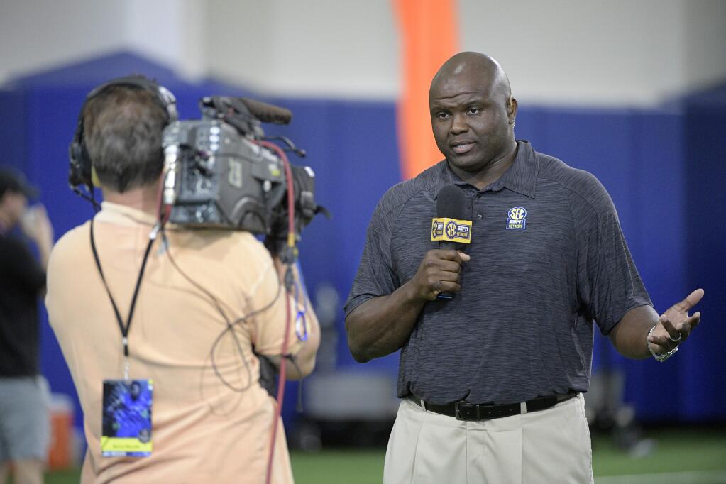 In this March 28, 2017, file photo, SEC Network analyst Booger McFarland, right, broadcasts during Florida's NFL Pro Day in Gainesville, Fla. Three new voices will work ESPN's Monday night games this NFL season: play-by-play announcer Joe Tessitore, analysts Jason Witten and Booger McFarland.(AP Photo/Phelan M. Ebenhack, File)