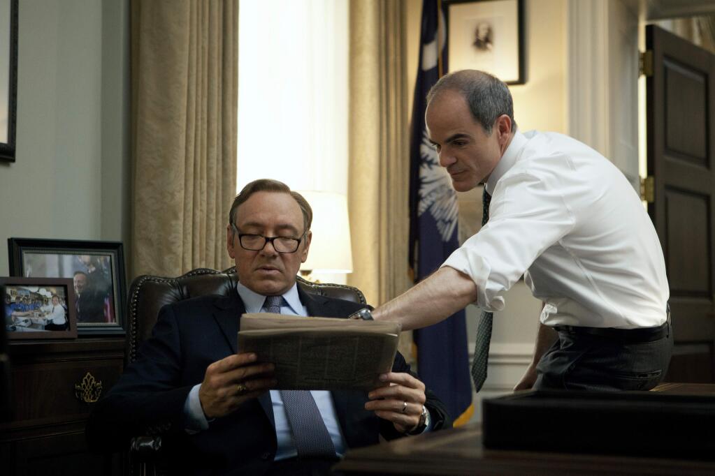 In this image released by Netflix, Kevin Spacey, left, and Michael Kelly appear in a scene from 'House of Cards.' The third season of the political drama will be available on Netflix on Friday Feb. 27, 2015. (AP Photo/Netflix)