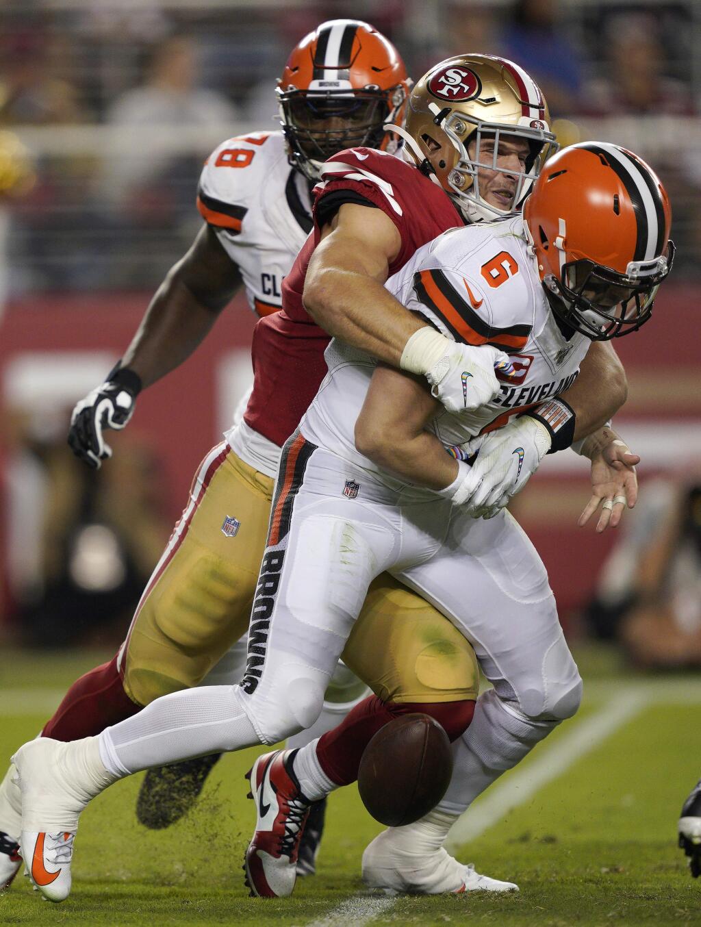 San Francisco 49ers defensive end Nick Bosa, center, sacks and forces a fumble by Cleveland Browns quarterback Baker Mayfield (6) during the second half of an NFL football game in Santa Clara, Calif., Monday, Oct. 7, 2019. The Browns recovered the ball. (AP Photo/Tony Avelar)