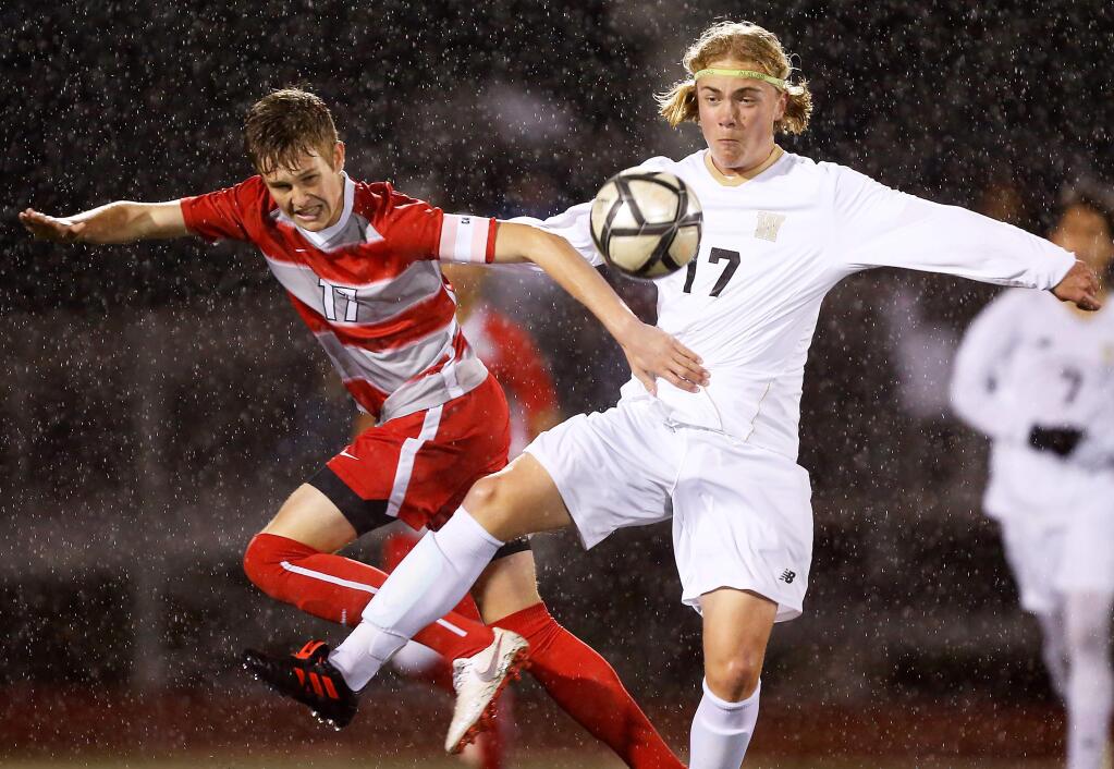 Montgomery's Kevin Welch (17), left, and Windsor's Flynn Stokeld (17) battle for ball possession during the first half of the NCS Division II boys varsity soccer playoff match between Windsor and Montgomery high schools in Santa Rosa, California, on Wednesday, February 13, 2019. (Alvin Jornada / The Press Democrat)