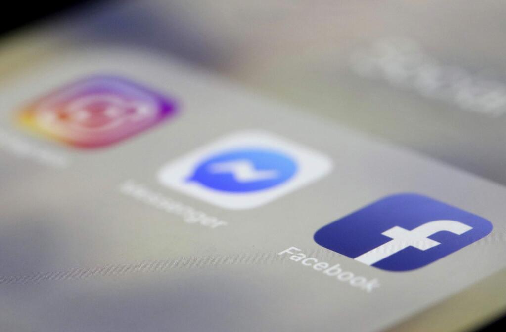 Facebook, Messenger and Instagram apps are are displayed on an iPhone on Wednesday, March 13, 2019, in New York. Facebook says it is aware of outages on its platforms including Facebook, Messenger and Instagram and is working to resolve the issue. (AP Photo/Jenny Kane)