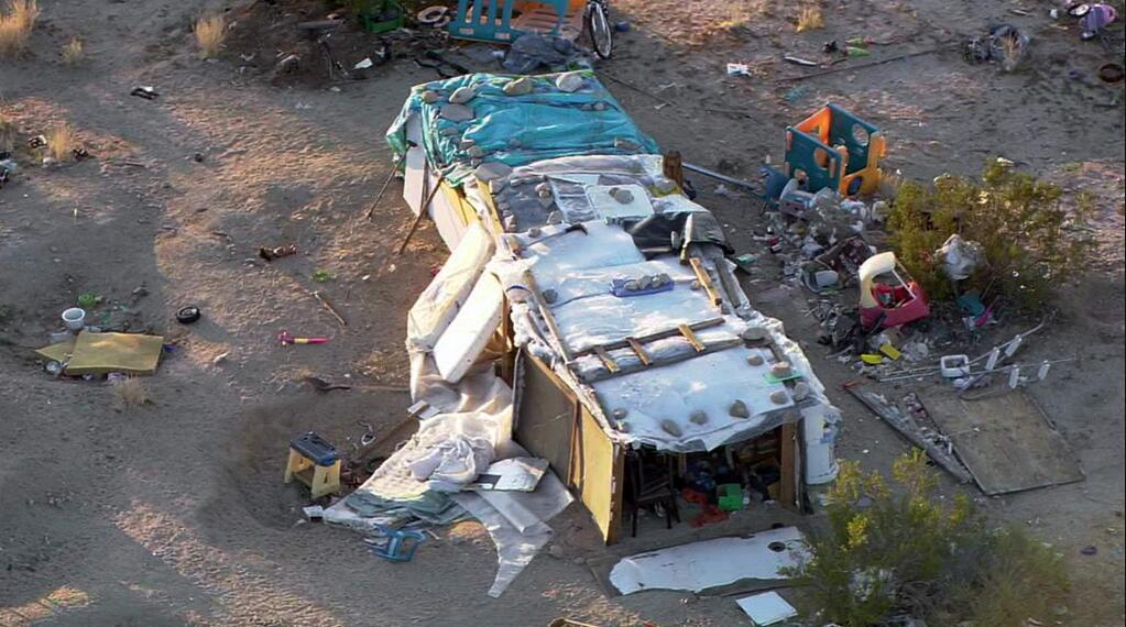 This aerial photo from video provided by KABC-TV shows a ramshackle structure where authorities say a couple, their three children and dozens of cats were living in filthy conditions in unincorporated Joshua Tree in Southern California's Mojave Desert on Thursday, March 1, 2018. The San Bernardino County Sheriff's Department says 73-year-old Daniel Panico and 51-year-old Mona Kirk were arrested Wednesday, Feb. 28, on charges of child cruelty. (KABC-TV via AP)
