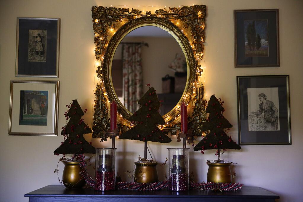 An array of Christmas decorations adorn a dresser in the master bedroom at Dianne and Tom Garcia's Sebastopol home. The home is featured on the Sebastopol Holiday Home Tour. (Christopher Chung/ The Press Democrat)
