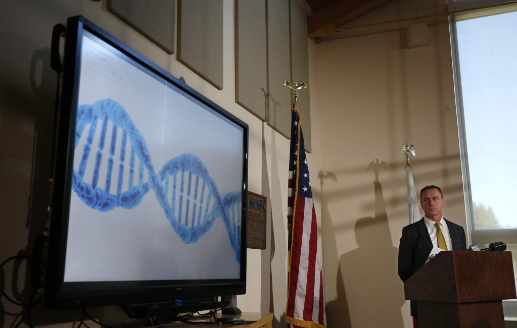 El Dorado County District Attorney Vern Pierson displays a generic genetic DNA ribbon as he discusses how new DNA evidence was used to help exonerate a man who spent about 15 years in prison after being wrongly convicted of killing his housemate, during a news conference in Placerville, Calif., Thursday, Feb. 13, 2020. Ricky Davis was convicted in 2004 of second degree murder in the stabbing death of a newspaper columnist. But the conviction was thrown out after new evidence was found implicating another person. (AP Photo/Rich Pedroncelli)