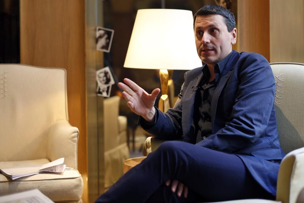 French writer Frederic Martel gestures during an interview with Associated Press, in Paris, Friday, Feb. 15, 2019. In the explosive book 'In the Closet of the Vatican' author Frederic Martel describes a gay subculture at the Vatican and calls out the hypocrisy of Catholic bishops and cardinals who in public denounce homosexuality but in private lead double lives. (AP Photo/Thibault Camus)