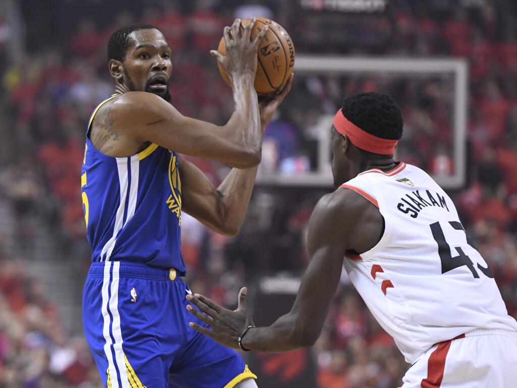 Golden State Warriors forward Kevin Durant, left, protects the ball from Toronto Raptors forward Pascal Siakam (43) during first-half basketball game action in Game 5 of the NBA Finals in Toronto, Monday, June 10, 2019. (Frank Gunn/The Canadian Press via AP)