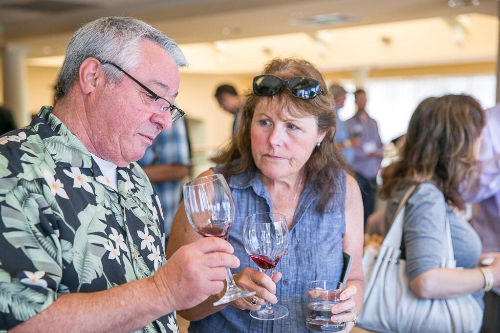 Richard and Linda Todero, of Southern California, share the wine tasting experience at Petaluma Gap's inaugural WIND to WINE Festival at the Sheraton Petaluma on Saturday, August 8, 2015. (RACHEL SIMPSON/FOR THE ARGUS-COURIER)